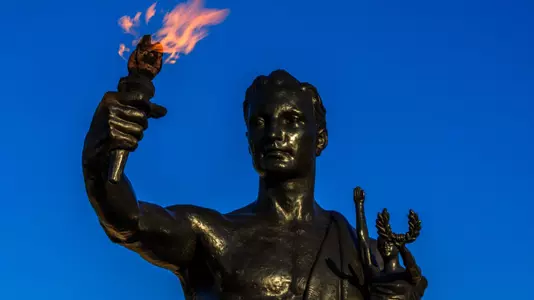 Torchbearer holds his torch high in Circle Park on the evening of April 02, 2020. Photo by Steven Bridges/University of Tennessee