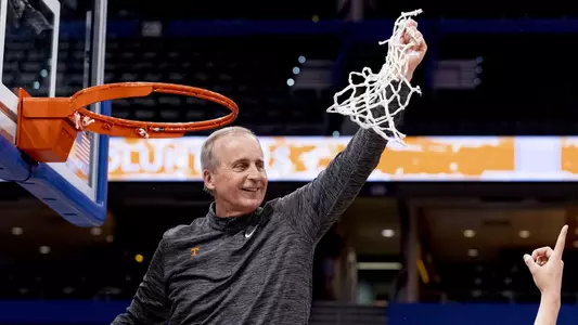 TAMPA, FL - March 13, 2022 - Head Coach Rick Barnes of the Tennessee Volunteers cuts down the net after winning the 2022 SEC Men's Basketball Tournament championship game between the Texas A&M Aggies and the Tennessee Volunteers at Amalie Arena in Tampa, FL. Photo By Andrew Ferguson/Tennessee Athletics