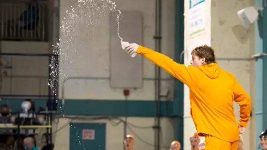 WILMINGTON, NC - October 01, 2021 - Luke Brice of the Tennessee Volunteers pours home water into the pool during the meet between the UNC Wilmington Seahawks and the Tennessee Volunteers at the Seahawk Natatorium Wilmington, NC. Photo By John Golliher/Tennessee Athletics