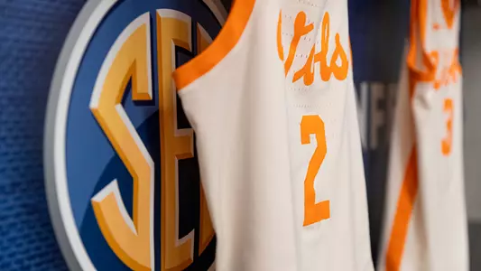 A Tennessee basketball jersey hangs beside the SEC logo