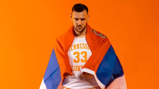 KNOXVILLE, TN - October 13, 2021 - Forward Uros Plavsic #33 of the Tennessee Volunteers with the flag of Serbia portrait taken at the Tennessee Theatre in Knoxville, TN. Photo By Andrew Ferguson/Tennessee Athletics