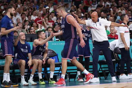 LILLE, FRANCE - JULY 31: Nikola Jokic #15 of Team Serbia high fives teammates during a Men's Group Phase - Group C game between Puerto Rico and Serbia on day five of the Olympic Games Paris 2024 at Stade Pierre Mauroy on July 31, 2024 in Lille, France. (Photo by Gregory Shamus/Getty Images)