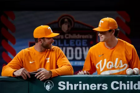 ARLINGTON, TX - February 18, 2024 - Director of Player Development Luke Bonfield and Pitcher Chris Stamos #27 of the Tennessee Volunteers during the Shriners Children?s College Showdown game between the Baylor Bears and the Tennessee Volunteers at Globe Life Field in Arlington, TX. Photo By Kate Luffman/Tennessee Athletics