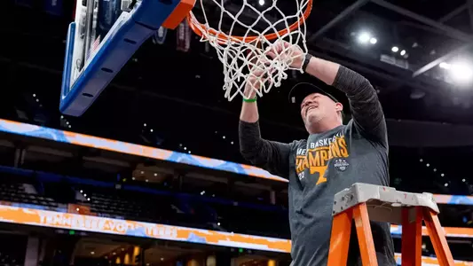 TAMPA, FL - March 13, 2022 - Senior Associate Director of Sports Medicine Chad Newman of the Tennessee Volunteers cuts the net after winning the 2022 SEC Men’s Basketball Tournament championship game between the Texas A&M Aggies and the Tennessee Volunteers at Amalie Arena in Tampa, FL. Photo By Andrew Ferguson/Tennessee Athletics