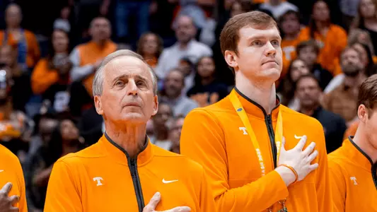 NASHVILLE, TN - March 16, 2025 - Associate Head Coach Justin Gainey, Head Coach Rick Barnes, Student Assistant Coach Colin Coyne, Graduate Assistant Isaiah Sulack, and Graduate Assistant Scott Daughtry of the Tennessee Volunteers during the national anthem before the championship game of the 2025 SEC Men's Basketball Tournament between the Florida Gators and the Tennessee Volunteers at Bridgestone Arena in Nashville, TN. Photo By Andrew Ferguson/Tennessee Athletics