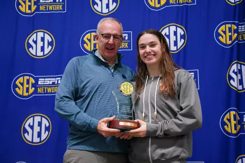 ATHENS, GA - February 22, 2025 - SEC Commissioner Greg Sankey presents Camille Spink of the Tennessee Volunteers the CommissionerÕs Trophy during the 2025 SEC Swimming and Diving Championship at Gabrielsen Natatorium in Athens, GA. Photo By Sidney Chansamone
