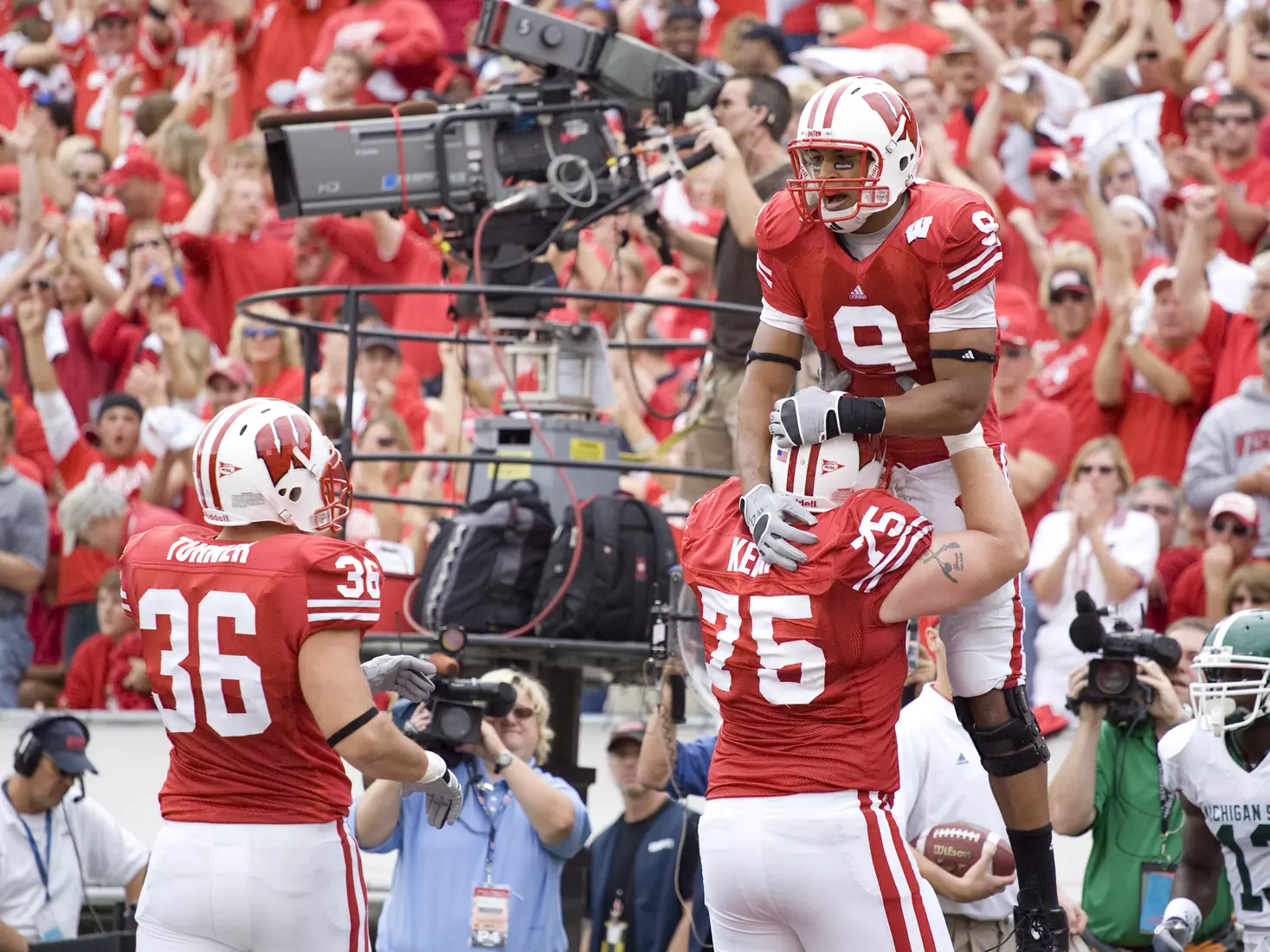 Offensive lineman Andy Kampman #75 of the Wisconsin Badgers celebrates Travis Beckum #9 touchdown against the Michigan State Spartans at Camp Randall Stadium on September 29, 2007 in Madison, Wisconsin. The Badgers beat the Spartans 37-34.
