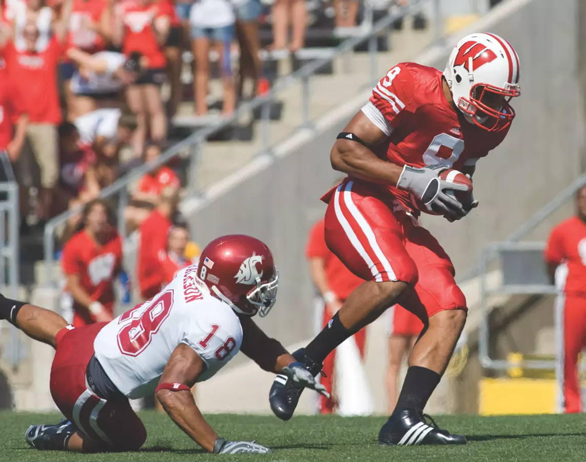 Tight end Travis Beckum #9 of the Wisconsin Badgers breaks the tackle defensive back Alfonso Jackson #18 of the Washington State Cougars at Camp Randall Stadium on September 1, 2007 in Madison, Wisconsin. The Badgers beat the Cougars 42-21.