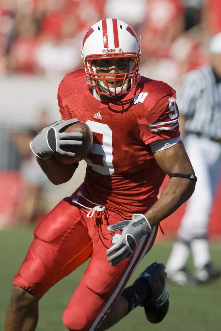 Tight end Travis Beckum #9 of the Wisconsin Badgers gains yardage after a reception against the Washington State Cougars at Camp Randall Stadium on September 1, 2007 in Madison, Wisconsin. The Badgers beat the Cougars 42-21.