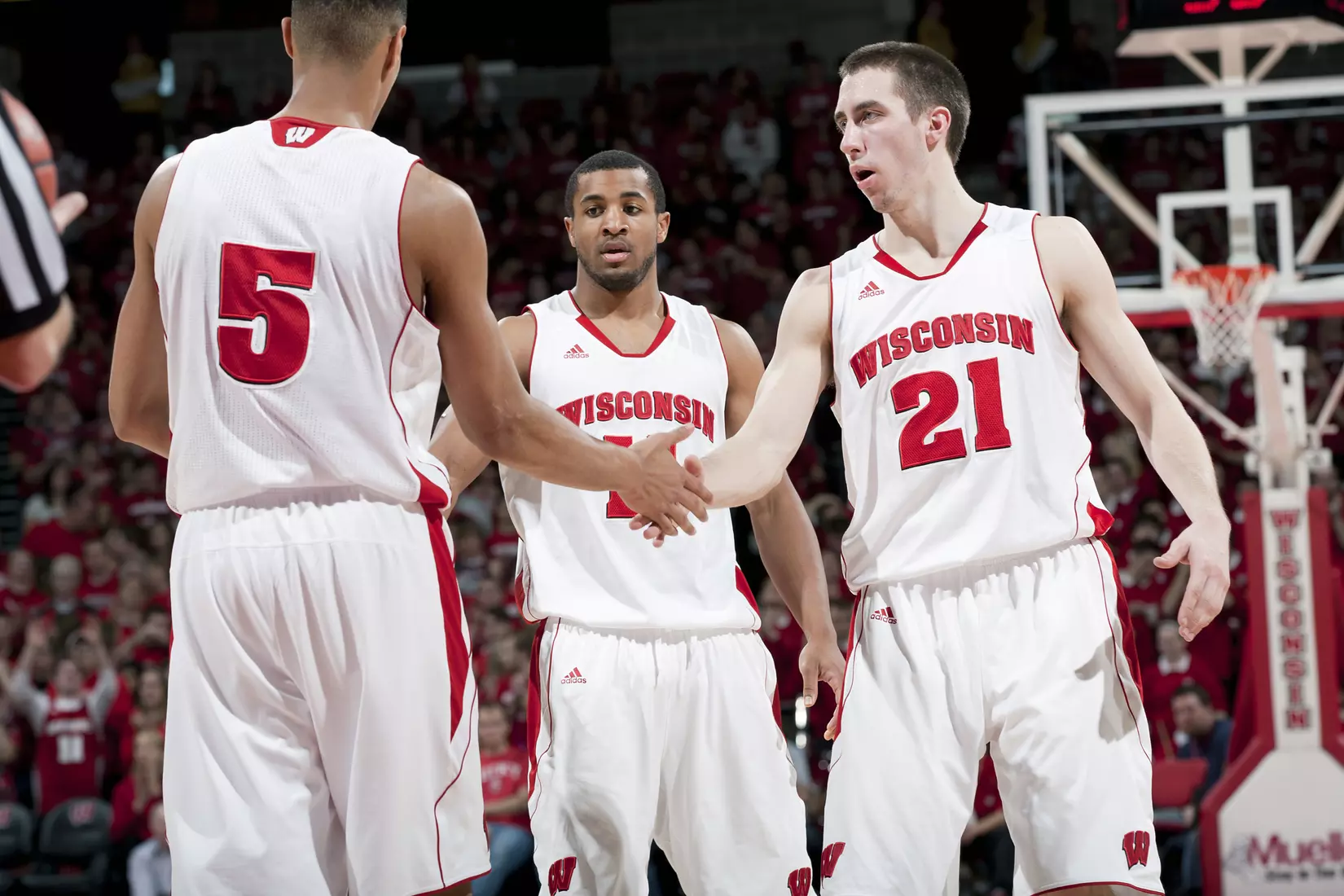 Wisconsin Badgers teammates Josh Gasser (21), Jordan Taylor (11) and Ryan Evans (5) during a Big Ten Conference NCAA college basketball game against the Penn State Nittany Lions on Sunday, February 19, 2012 in Madison, Wisconsin. The Badgers won 65-55. (Photo by David Stluka)