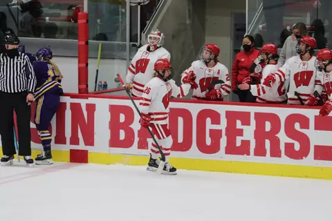 Casey O'Brien receives fist bumps from her teammates along the bench