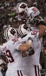 <b>Wisconsin running back David Gilreath, right, celebrates with teammates after Gilreath ran in a touchdown during the first quarter of the NCAA college football game against Hawaii, Saturday, Dec. 5, 2009 in Honolulu. (AP Photo/Marco Garcia)</b>