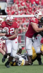 <b>Gabe Carimi helps open a hole for John Clay.</b>