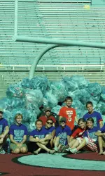 <b>Maggie Galloway (legs crossed) and REthink Wisconsin at Camp Randall Stadium</b>