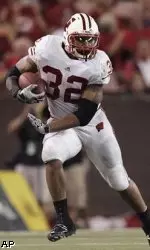 <b>Wisconsin running back John Clay runs around the Hawaii defensive line during the second quarter</b>