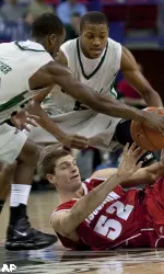 <b>Wisconsin's Keaton Nankivil (52) tries to keep control of the ball as Wisconsin-Green Bay's Rahmon Fletcher (20) and Rian Pearson try to take it during the first half of an NCAA college basketball game Wednesday, Dec. 9, 2009, in Green Bay, Wis. (AP Photo/Mike Roemer)</b>