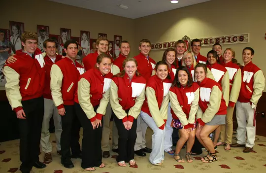 Men's and women's swimming and diving with their letter jackets