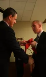 <b>Tyler Holland accepts his graduation stole from Steve Waterfield.</b>