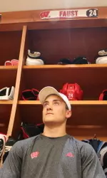 <b>Junior defenseman Joe Faust takes in the new men's hockey locker room after filling his stall</b>