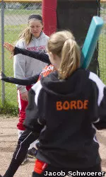<b>UW starting catcher Maggie Strange worked with campers on their swing.</b>