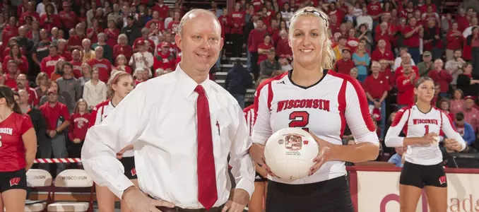 Romana Kriskova is presented with a ball recognizing her for 1,000 career kills by head coach Kelly Sheffield.