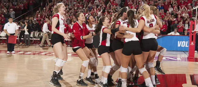 The Badgers rush the court after being Iowa State