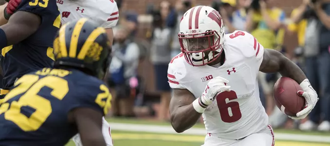 Corey Clement runs the football against Michigan