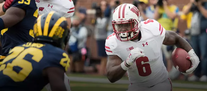 Corey Clement runs the football against Michigan