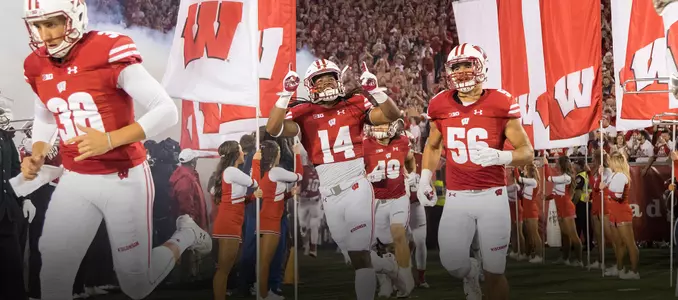 D'Cota Dixon and Zack Baun run out of the tunnel prior to Wisconsin vs. Ohio State