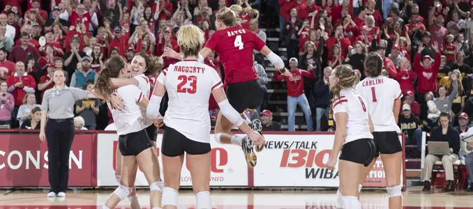 The Badger team celebrates match point over Iowa.