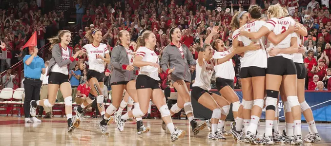 The Badger volleyball team celebrates its second-round win over WSU.