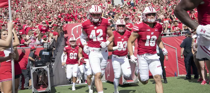 Football 2016 Team running out of tunnel T.J. Watt, Leo Musso, T.J. Edwards