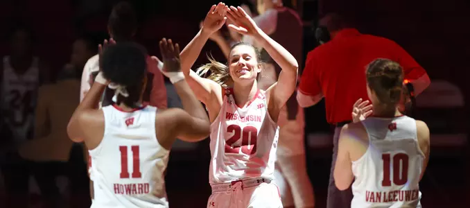 Taylor Kuhn slaps the hands of Marsha Howard during starting lineups.