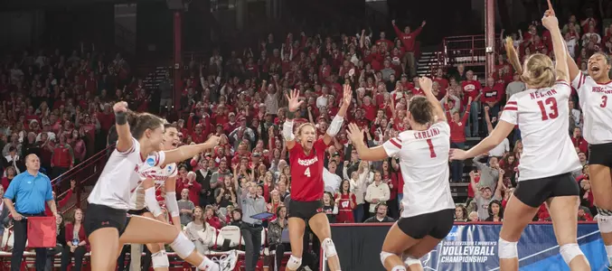 The Badger volleyball team celebrates match point