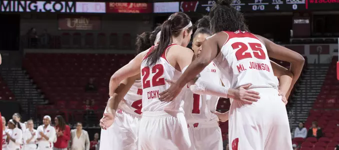 The Badger women's basketball team huddles on the court