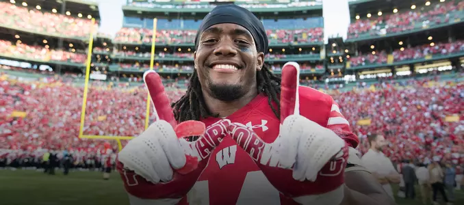 D'Cota Dixon flashes the W after Wisconsin's win at Lambeau Field