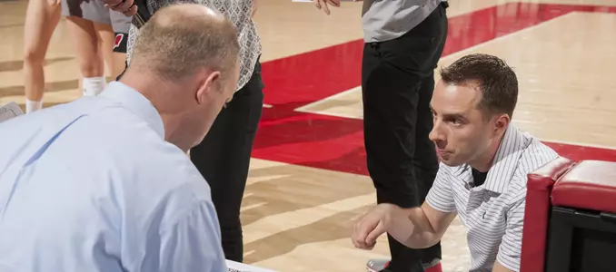 Volleyball coaches talk on the bench