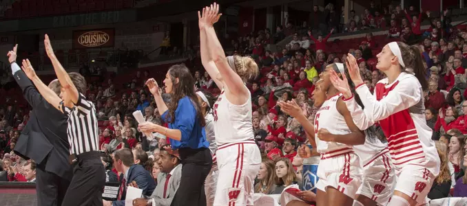 The Badger bench celebrate a 3-pointer