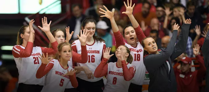 The Badgers bench celebrates during a match in the UW Field House.