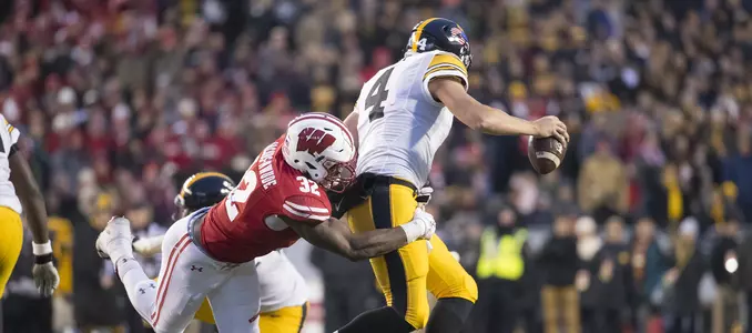 Photo of Leon Jacobs tackling Iowa's quarterback football 2017