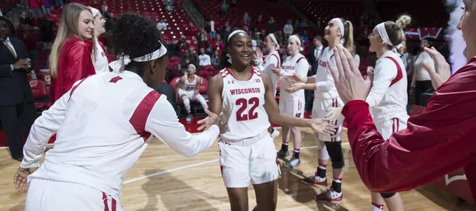 Niya Beverley slaps the hands of her teammates during starting lineups