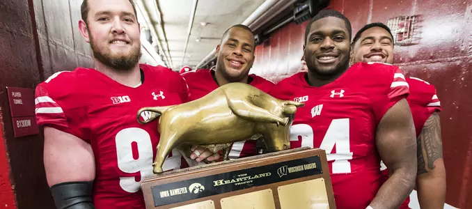 Photo of Conor Sheehy, Chikwe Obasih, Alec James, Olive Sagapolu with Heartland Trophy football vs. Iowa 2017