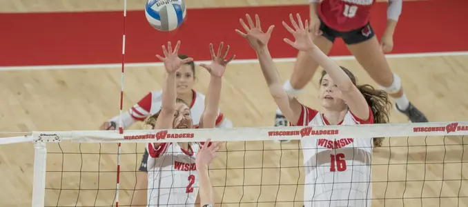 Sydney Hilley and Dana Rettke go up for a block against a Marquette player.