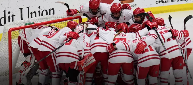 Women's hockey huddles before a game