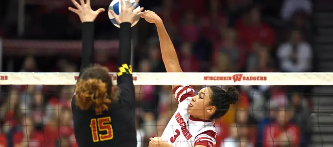 Lauryn Gillis attacks the ball against a Maryland blocker.