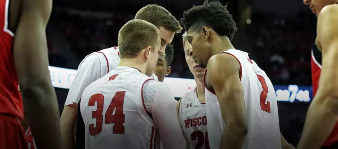 Badgers huddle during a break in the action vs. Western Kentucky