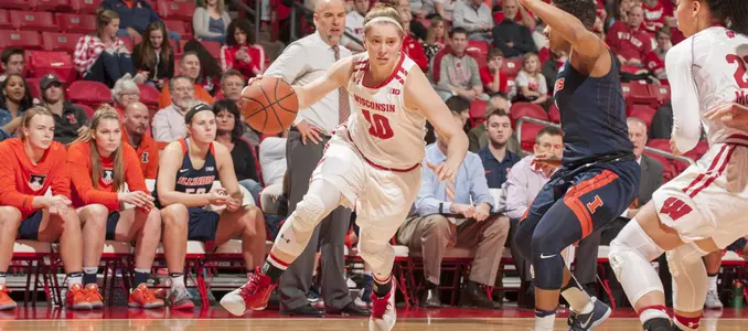Kendra Van Leeuwen drives around an Ilinois defender