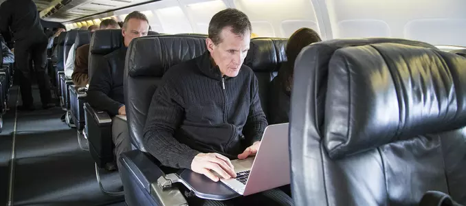 Men's hockey 2017 Tony Granato using laptop on plane