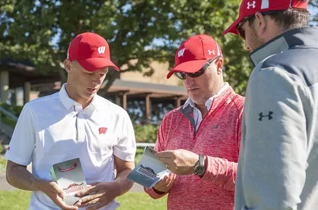 Head coach Michael Burcin and assistant coach Blain Woodruff meet with Pete Kuhl prior to the opening round of the 2016 Badger Invitational