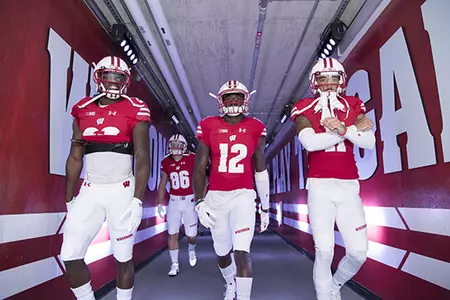 Photo of Football vs. Akron 2016 Natrell Jamerson, Jazz Peavy and teammates walking out of the Camp Randall Stadium tunnel